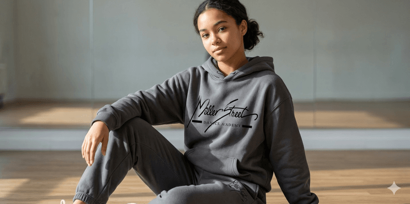 Female dancer wearing MSDA charcoal hoodie and sweatpants set